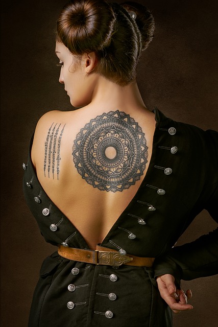 Woman with mandala tattoo on her upper back