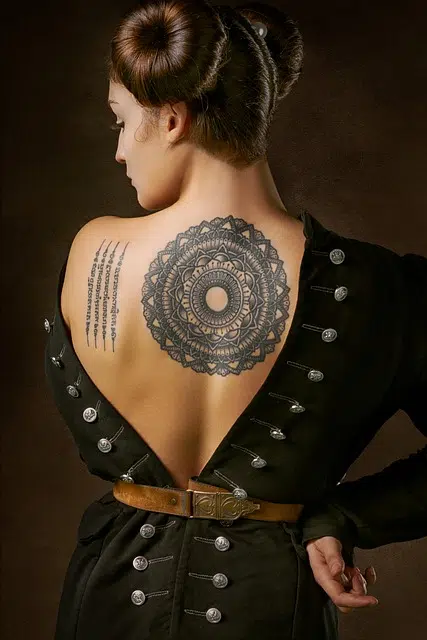 Woman with mandala tattoo on her upper back