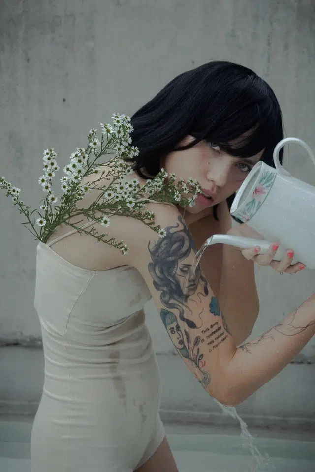 Woman pours water on her tattoo