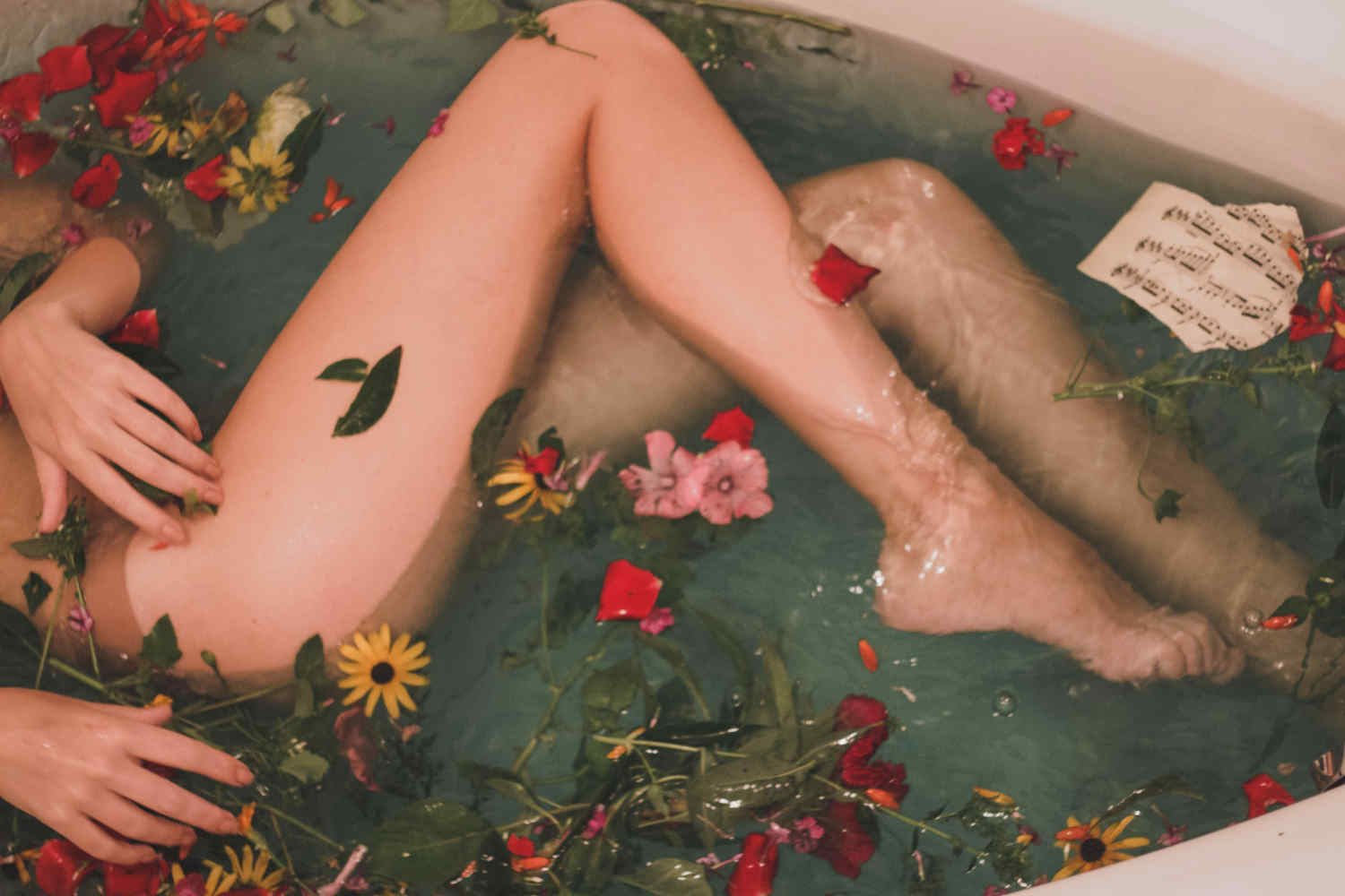 Woman soaks in a floral bath
