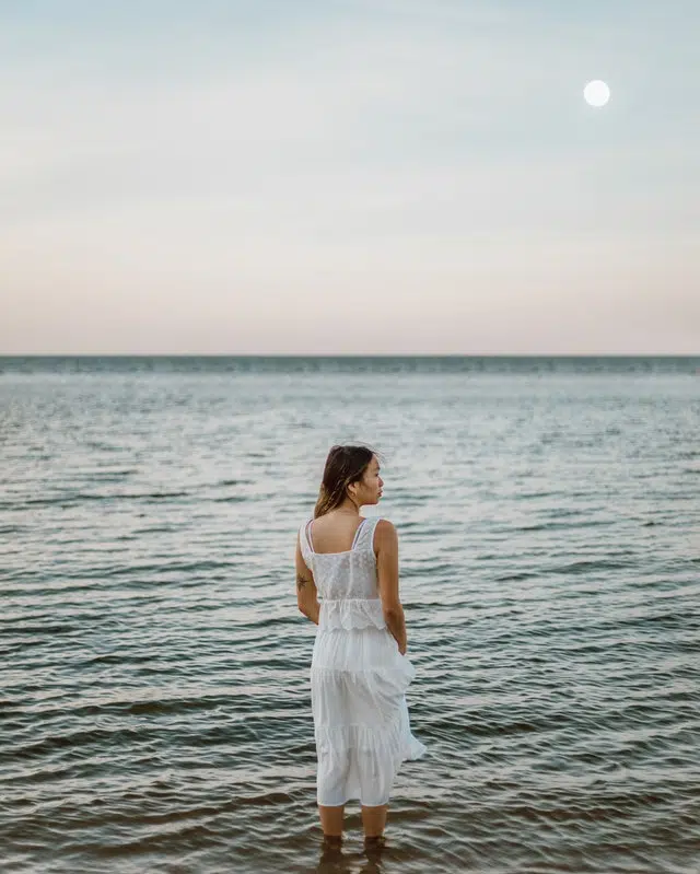 Woman in White Dress Standing on Seaside