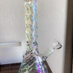 iridescent bong with ice catcher on wooden table