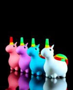 silicone unicorn pipes lined up on black table