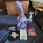 mushroom bong with stickers on bed