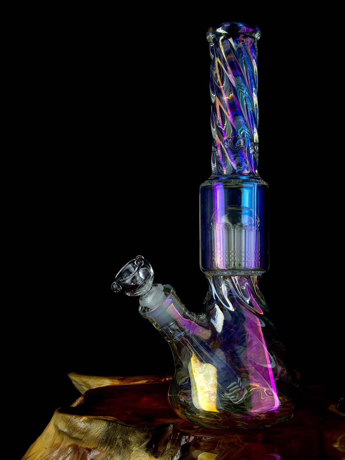 twisted iridescent bong with percolator on wooden table
