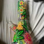 handpainted flower bong made from borosilicate glass on bed