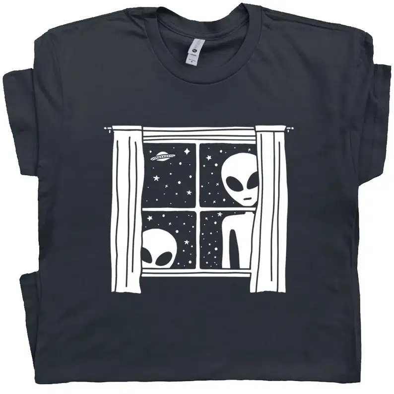 Black t-shirt featuring the landing of aliens at Roswell as seen through a window