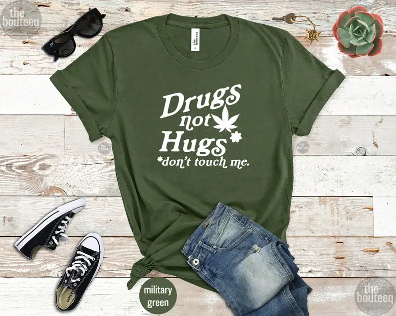 Green t-shirt that says "Drugs not Hugs" and "Don't Touch Me"
