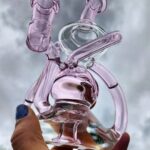 holding up pink recycler bong to sky