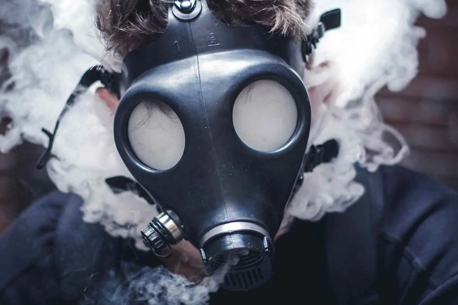 man using gas mask bong