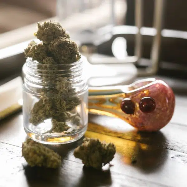 spoon pipe and jar of weed