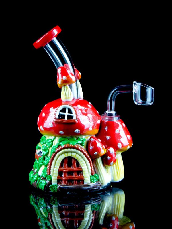 mushroom dab rig with hand painted design resembling a mushroom cottage house