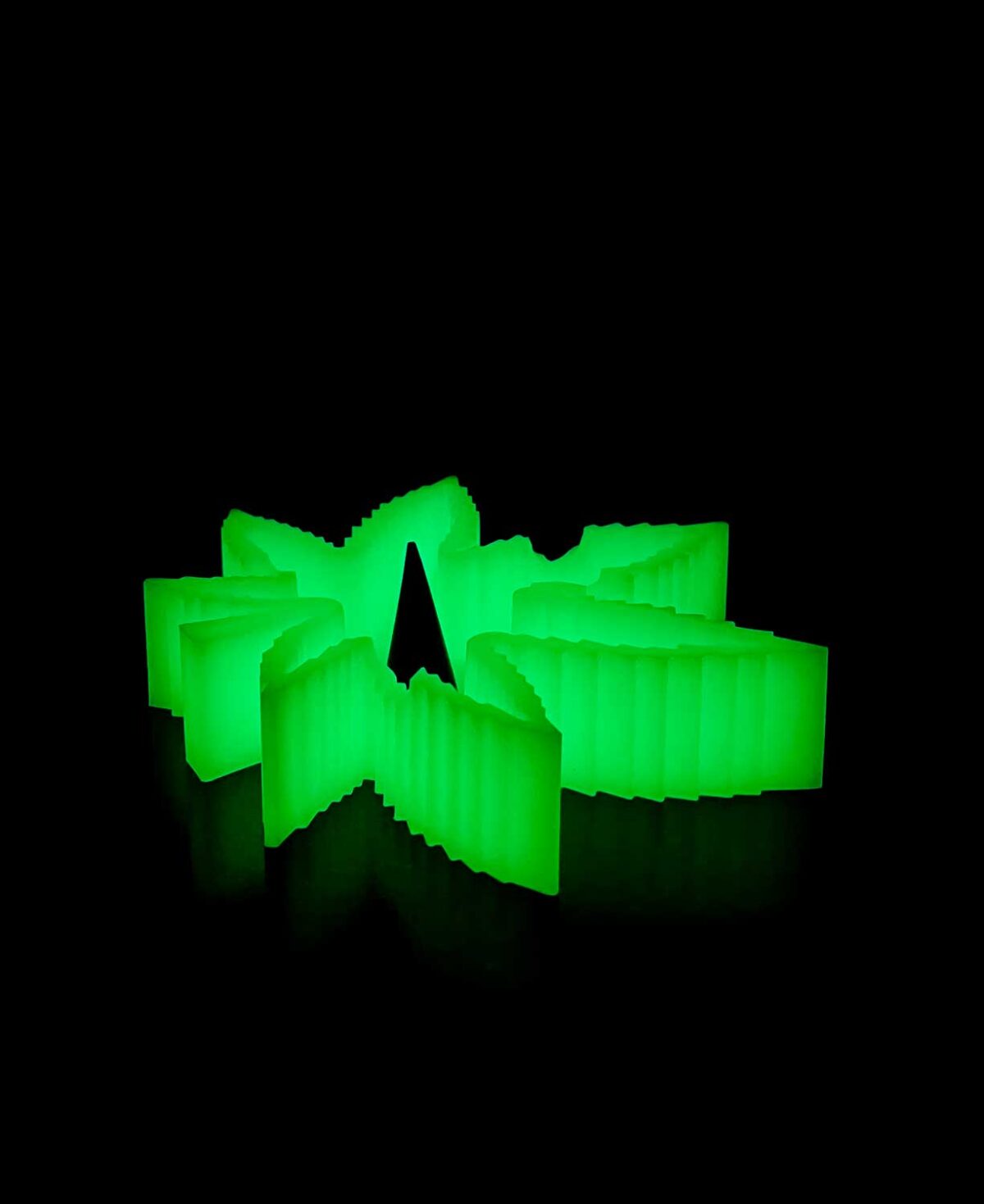 silicone debowler ashtray in the shape of a weed leaf glowing in the dark