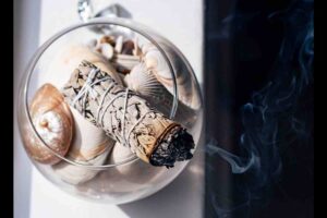 burning sage and crystal in a bowl