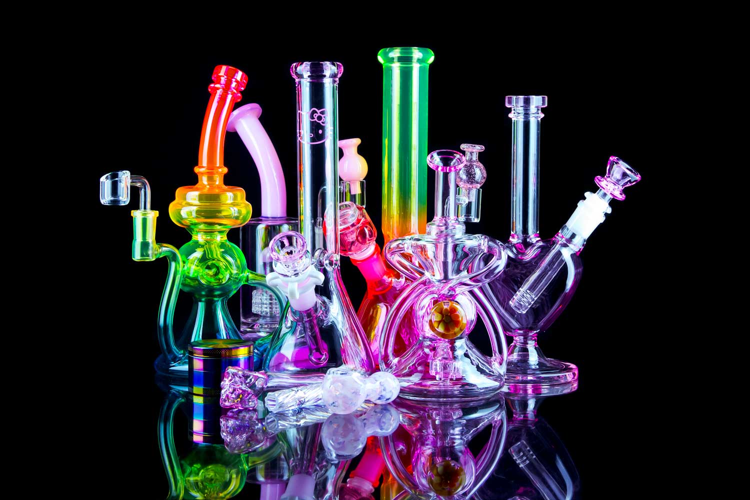 pink bongs dab rigs pipes grinders and bong bowls collection with reflection on glass