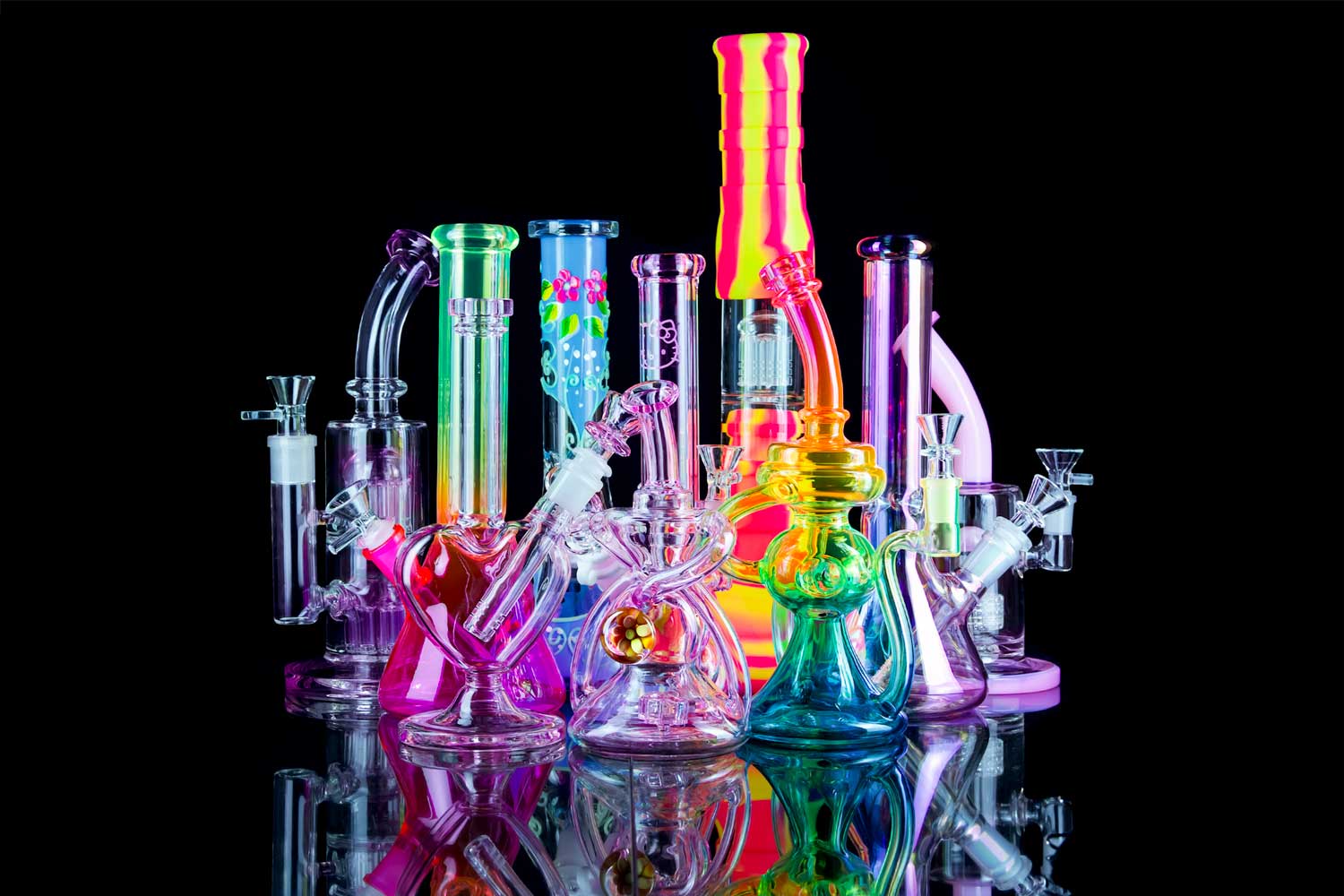 pink bong collection with reflection on black table