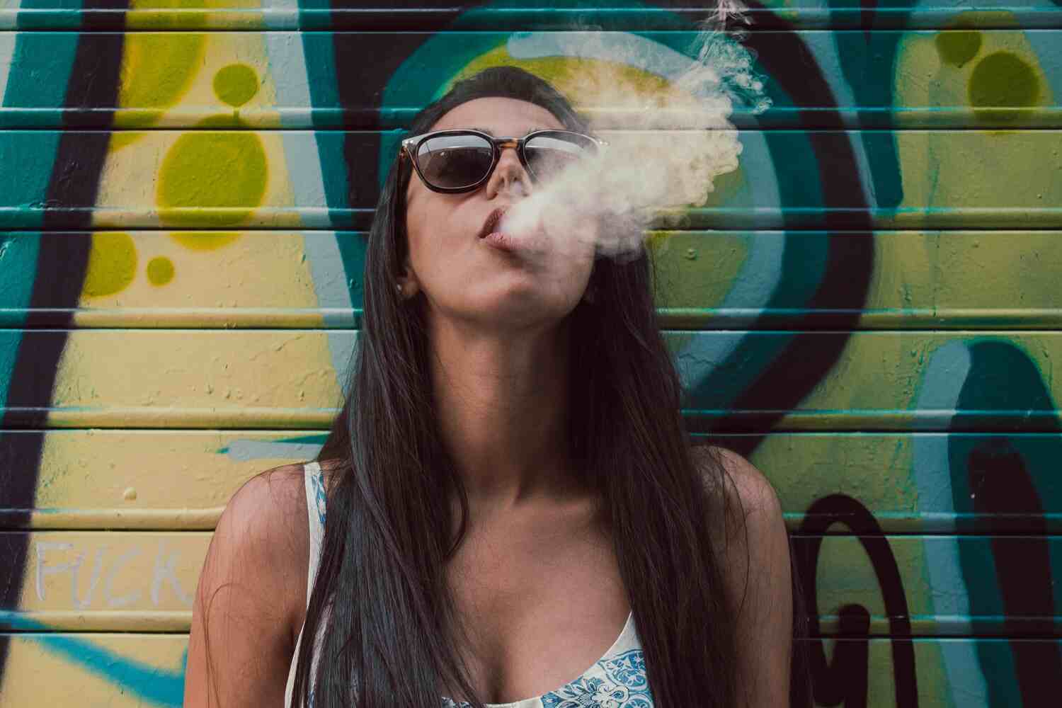 woman blowing out a puff of smoke