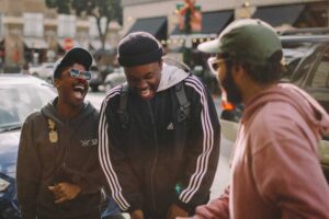 asking a stranger for weed three guys laughing in city center