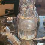 iridescent bong with percolator on table
