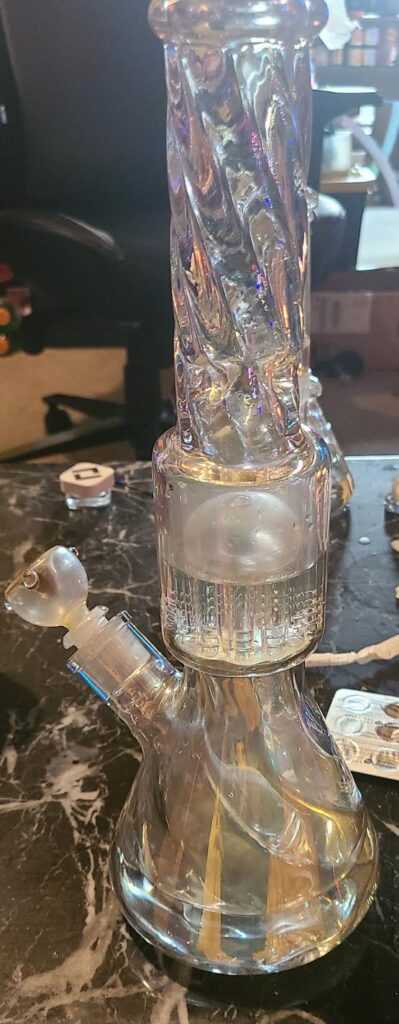 iridescent bong with percolator on table