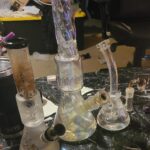 iridescent bongs with percolators on table