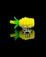 keychain pipe pineapple on black table with glass bowl