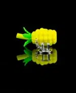 keychain pipe pineapple on black table with glass bowl