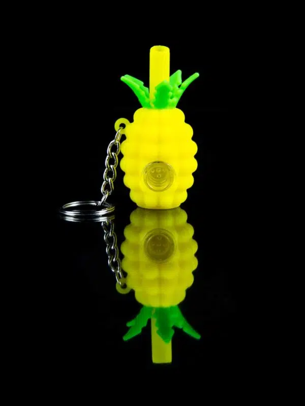 pineapple keychain pipe with glass bowl on black table