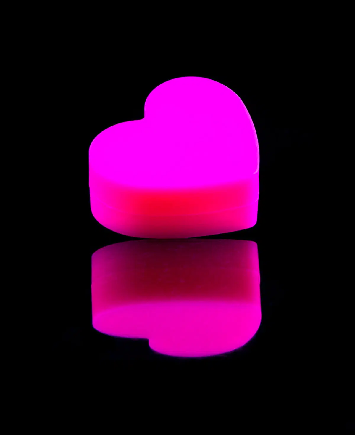 heart dab container in pink on black table