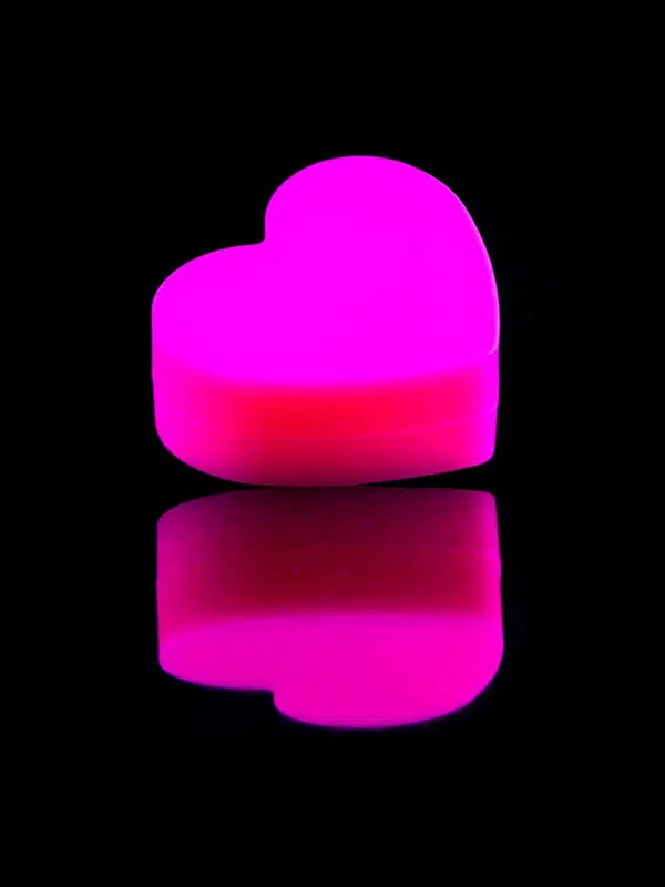 heart dab container in pink on black table