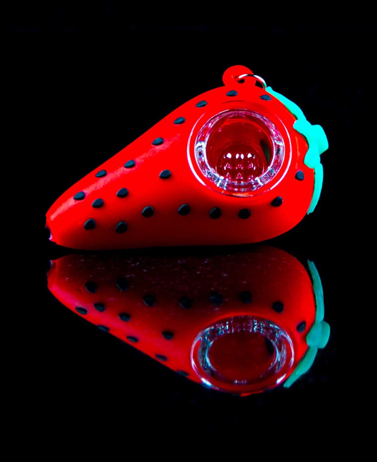 strawberry pipe keychain with glass bowl on black table