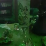 rick and morty bong on table with tv in the background