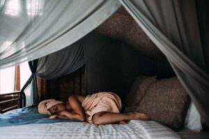 woman sleeping in bed with towels