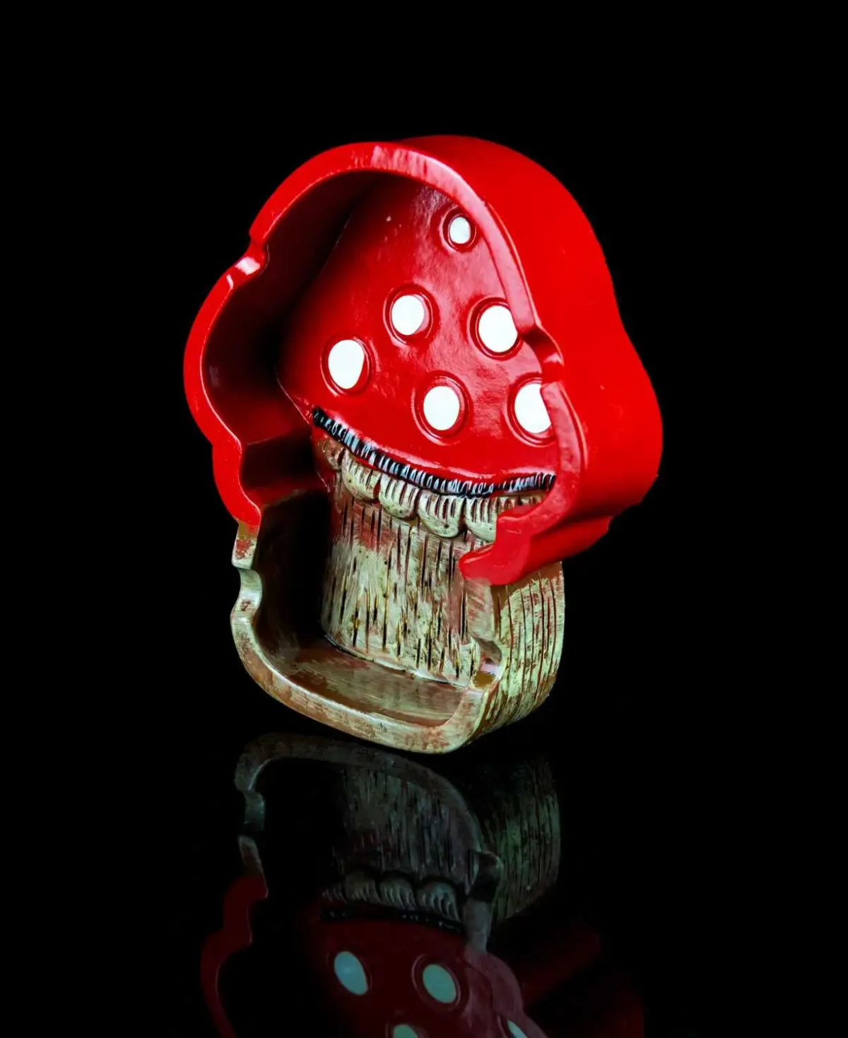 mushroom ashtray in red on black table