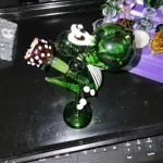 yoshi bong on table with other smoking acessories