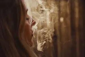 woman smoking weed with eyes closed