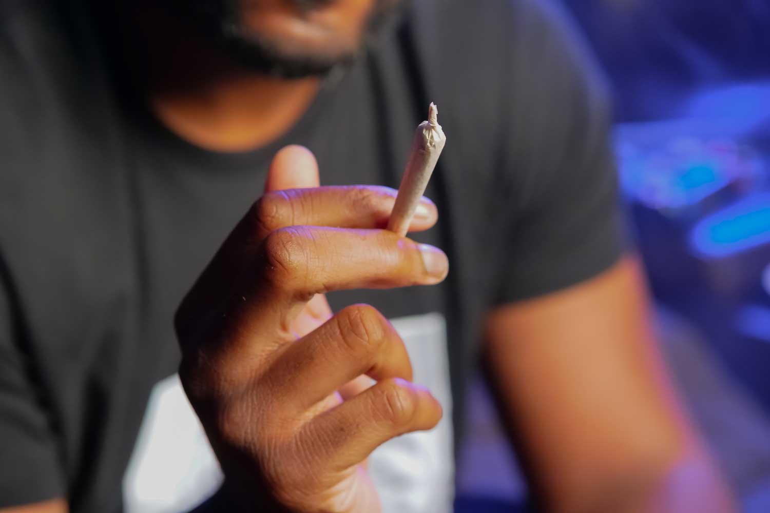 man holding a joint closeup of hand