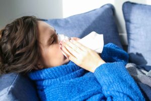 woman sneezing after smoking weed