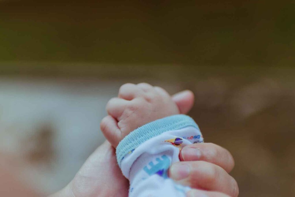 holding baby's hand