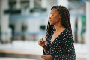 woman smoking disposable weed pen