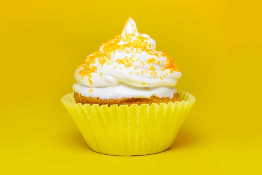 cupcake with yellow sprinkles on yellow background