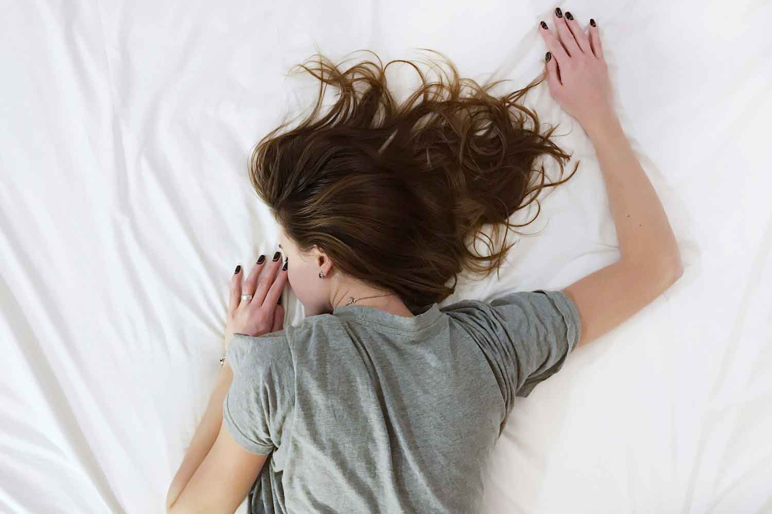 woman tired on bed after smoking weed